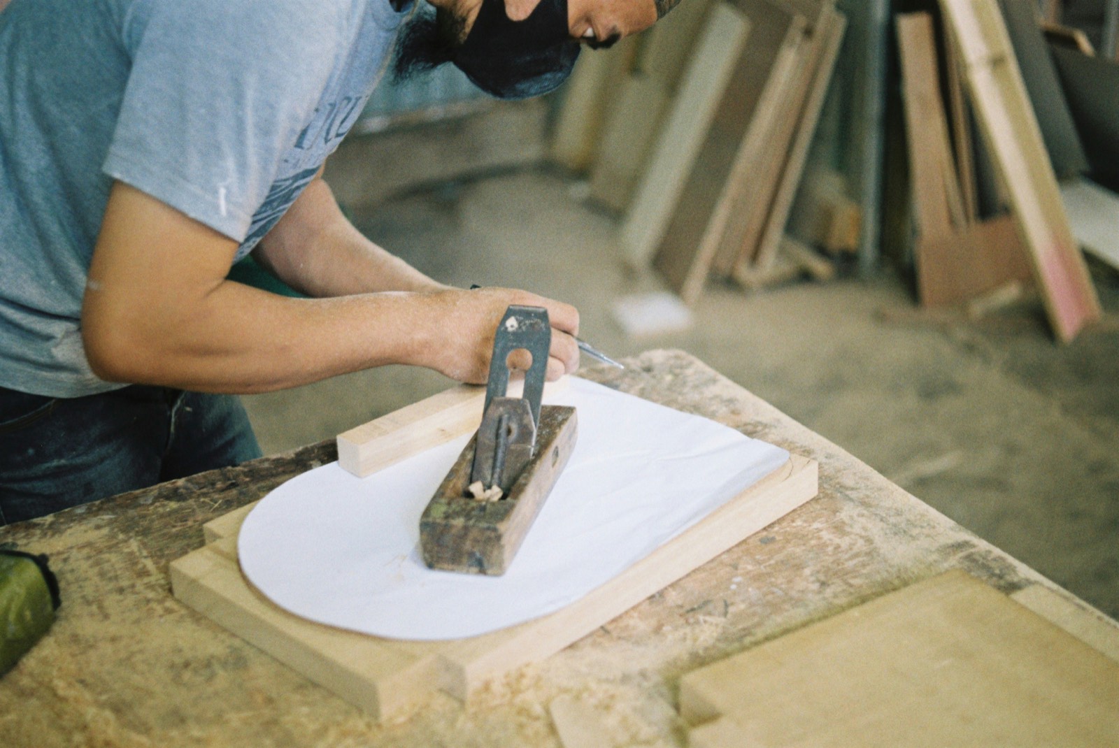 Person planing a curved piece of wood