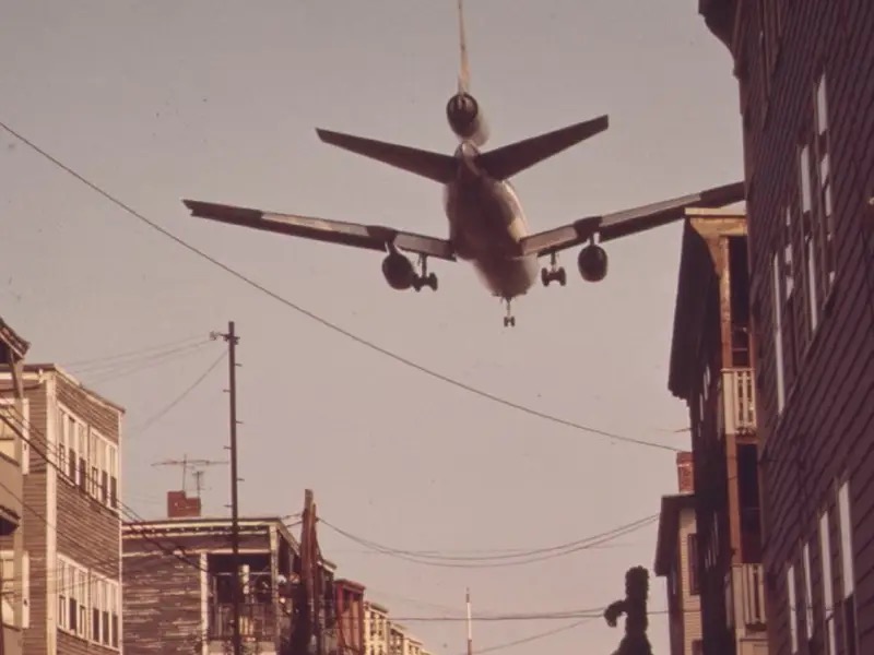 Plane flying low over a city street