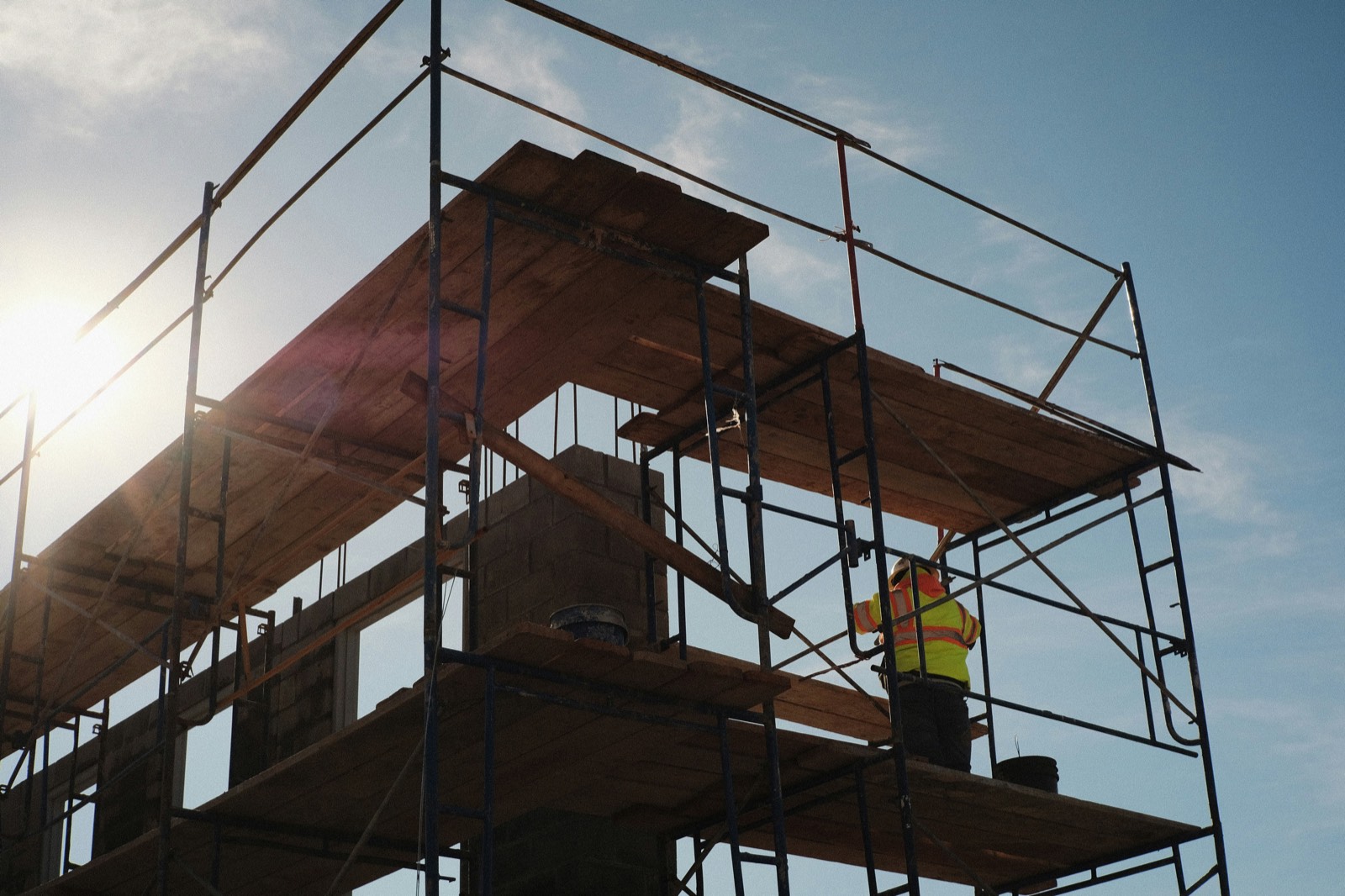 Worker on wooden scaffolding