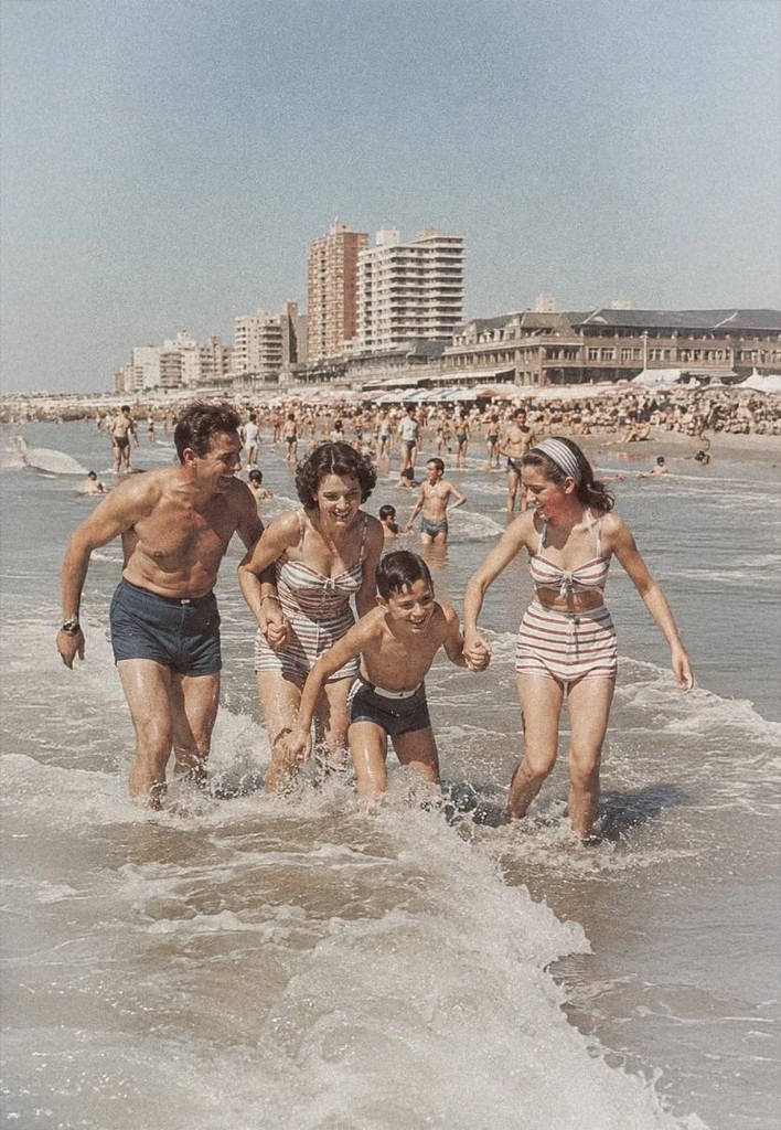 Family running out of the ocean